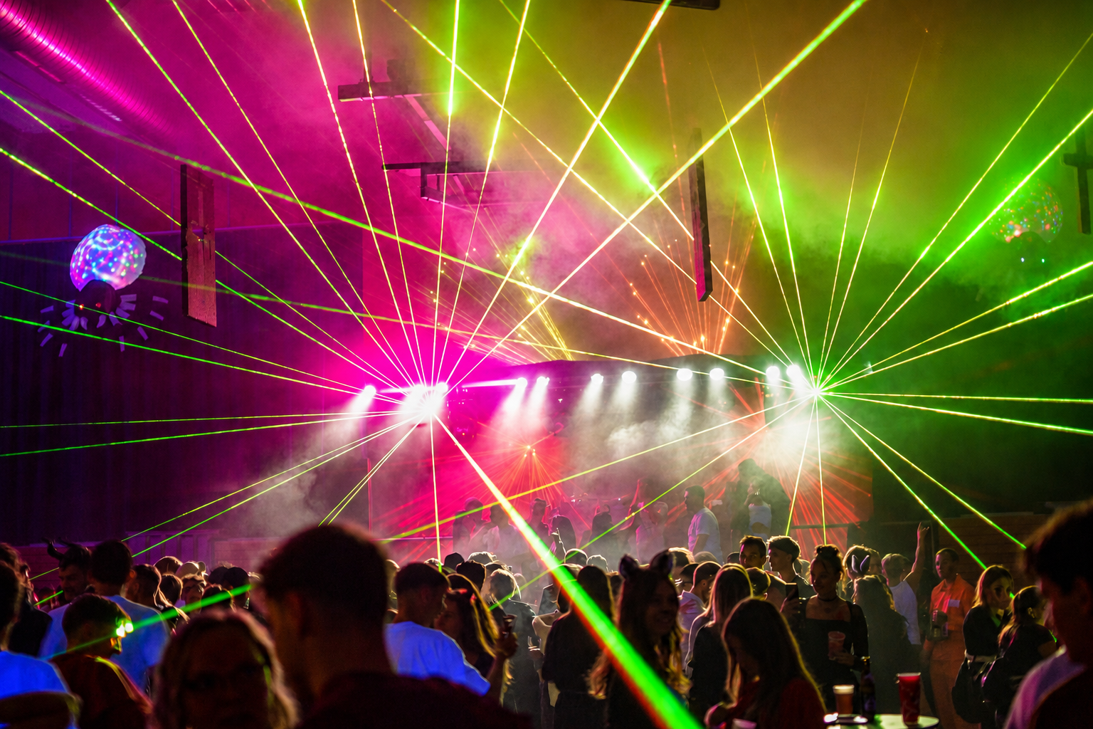 Festival crowd with a laser show at night